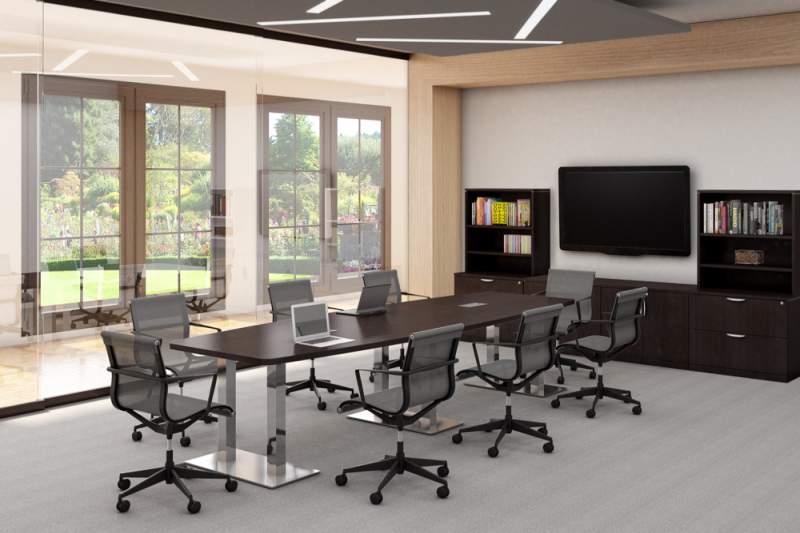 Medium sized dark brown conference table with a laptop on top